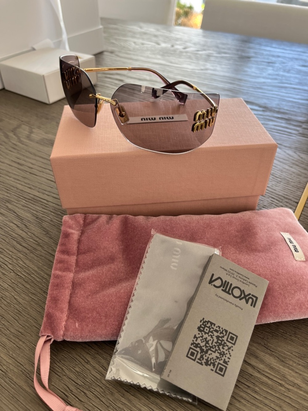 Miu Miu Black Sunglasses with Gold Accents